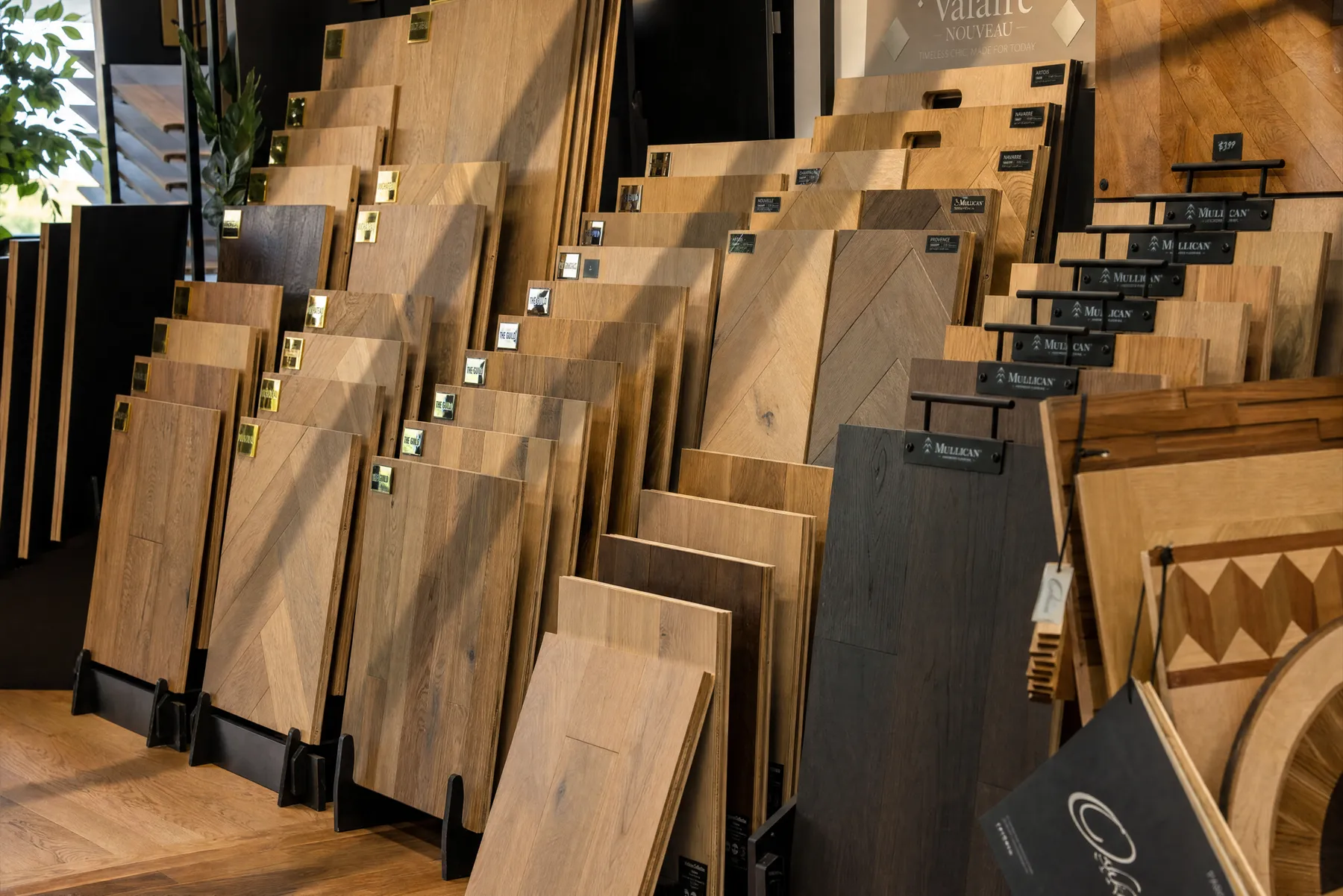 Rows of hardwood and vinyl sample boards in the Grain Design Flooring showroom
