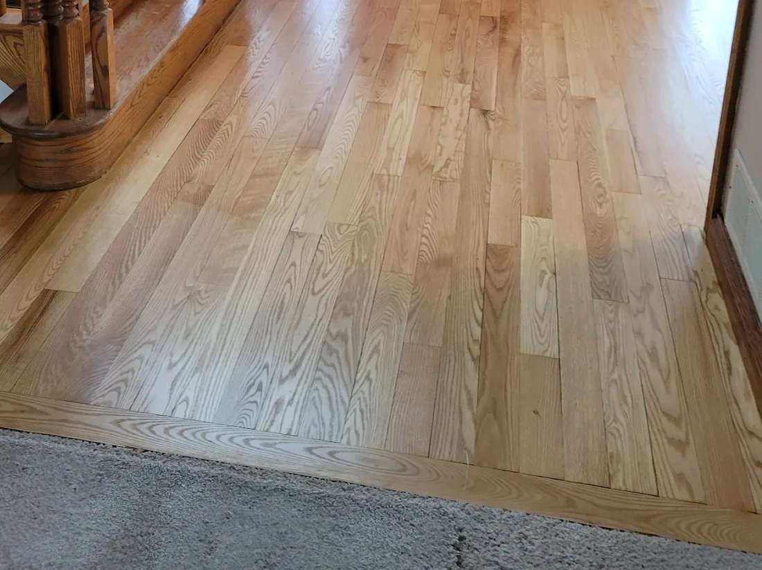 Detail of the refinished red oak boards at the stair landing